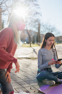 Female friends doing work during protest