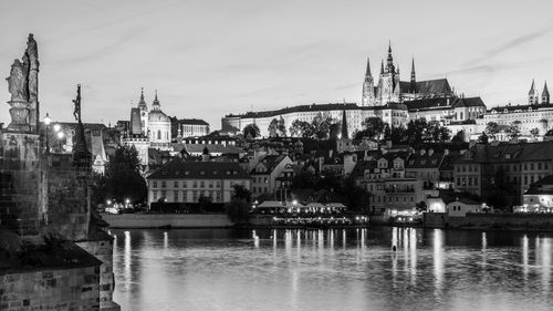 Buildings by river in city