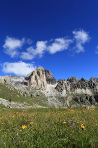 Scenic view of mountains against blue sky