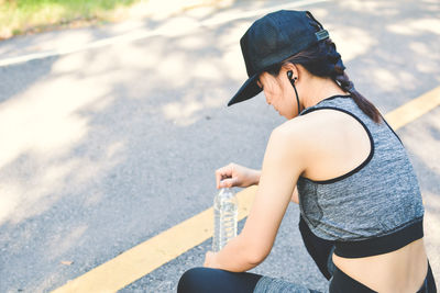 High angle view of sports woman resting by road