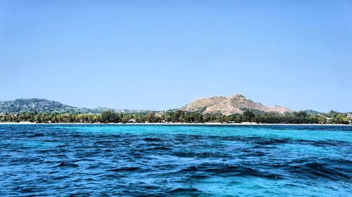 Scenic view of sea against clear blue sky