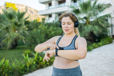 Portrait of young woman exercising in park