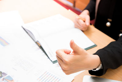 Close-up of woman working at table