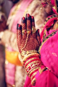 Midsection of bride with bridegroom during wedding ceremony