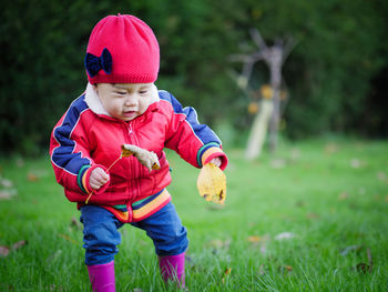 Cute baby boy standing at park