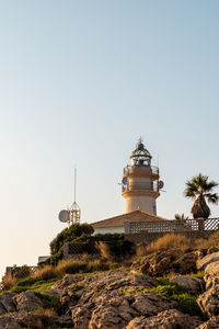 Sunrise over the lighthouse of cullera, valencia.