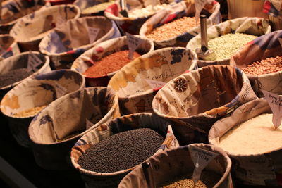 Lentils and seeds in container at market for sale