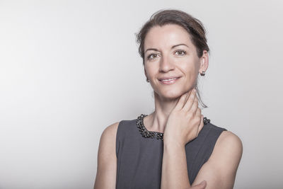 Portrait of a smiling young woman over white background