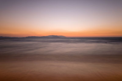 Scenic view of sea at sunset