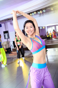Smiling woman exercising in gym