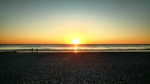 Scenic view of sea against clear sky during sunset