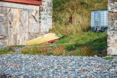 Garbage by stone wall of building