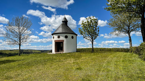 Built structure on field against sky