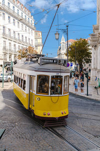 Yellow train on city street