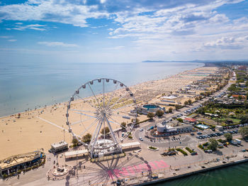 High angle view of cityscape by sea against sky