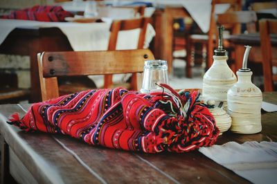 Close-up of red object on wooden table