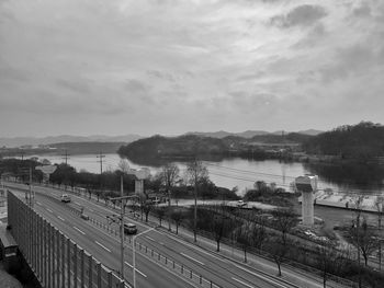 High angle view of road by lake against sky