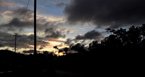 Silhouette trees against sky during sunset