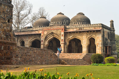 A bada gumbad monument at lodi garden in a city park from the side of the lawn.