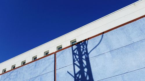 Low angle view of building against clear blue sky