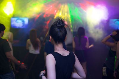 Rear view of people enjoying at nightclub