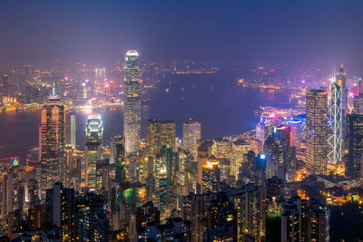 Illuminated cityscape against sky at night