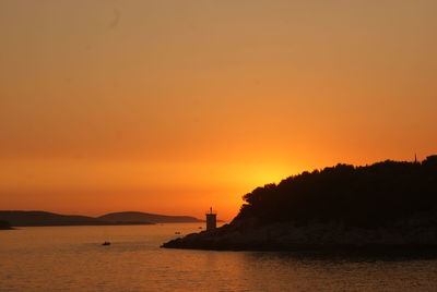 Scenic view of sea against orange sky