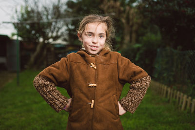 Portrait of smiling girl standing on land