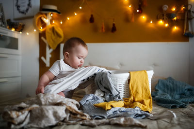 Portrait of boy sleeping on bed at home