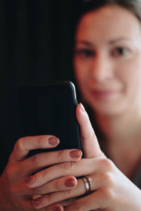 Close-up portrait of woman using mobile phone