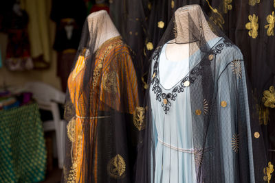 Different abaya style dresses displayed in the shop in dubai souq