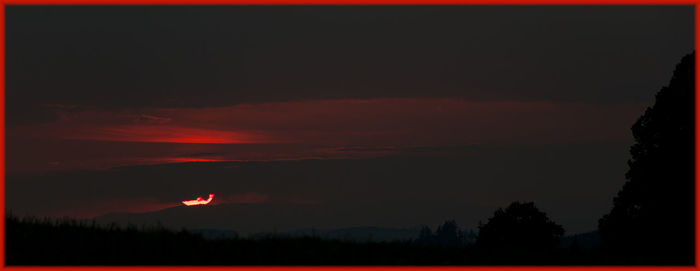 Silhouette of landscape against dramatic sky