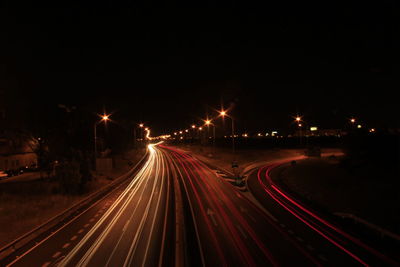 High angle view of light trails on road at night