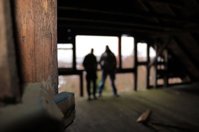 Close-up of wood while people standing in background