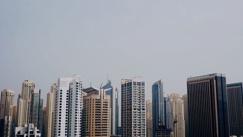 Modern cityscape against clear sky