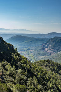 High angle view of sea and mountains against sky