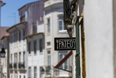 Close-up of road sign against buildings in city