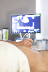 Cropped image of doctor examining patient at hospital