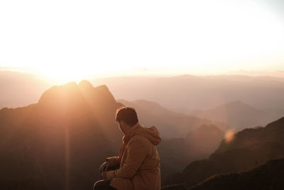Man looking at mountains during sunrise
