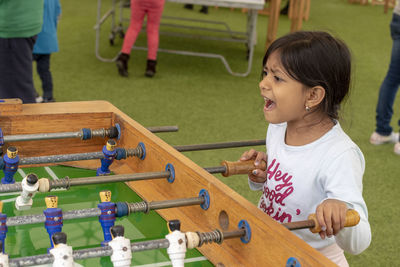 Cute girl playing foosball 