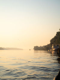 Scenic view of sea against clear sky during sunset