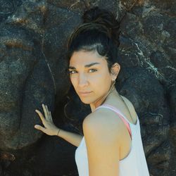 Portrait of woman standing on rock