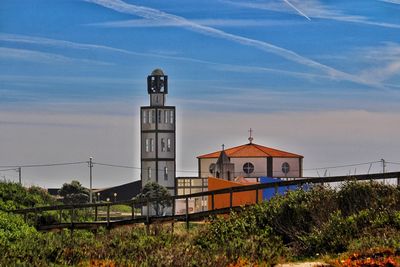 Church by building against sky