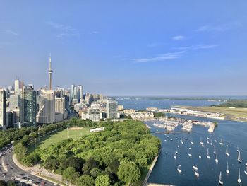 High angle view of buildings by sea against sky