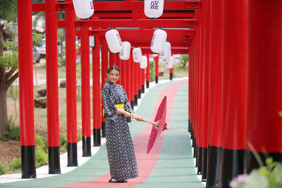 Portrait of man holding red umbrella