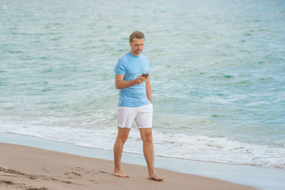 Full length of man standing at beach