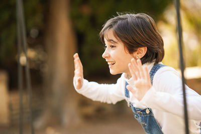 Portrait of smiling young woman looking away outdoors