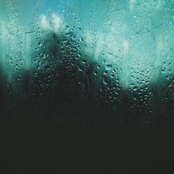 Full frame shot of raindrops on glass window