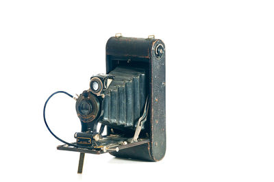 Close-up of old machine against white background