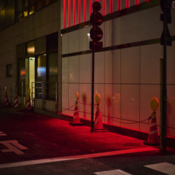 Rear view of woman walking on street at night